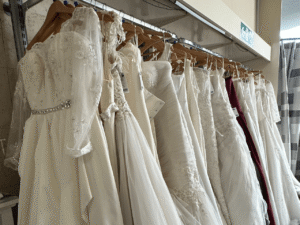 a selection of wedding dresses on a rail