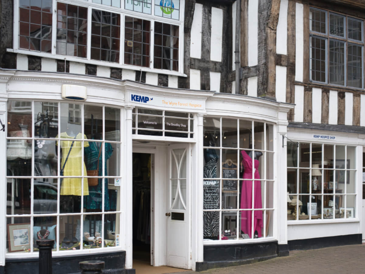 outside of a charity shop. White building with brown beams