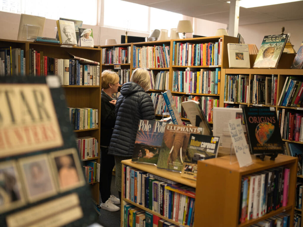 two ladies looking at books on shelves