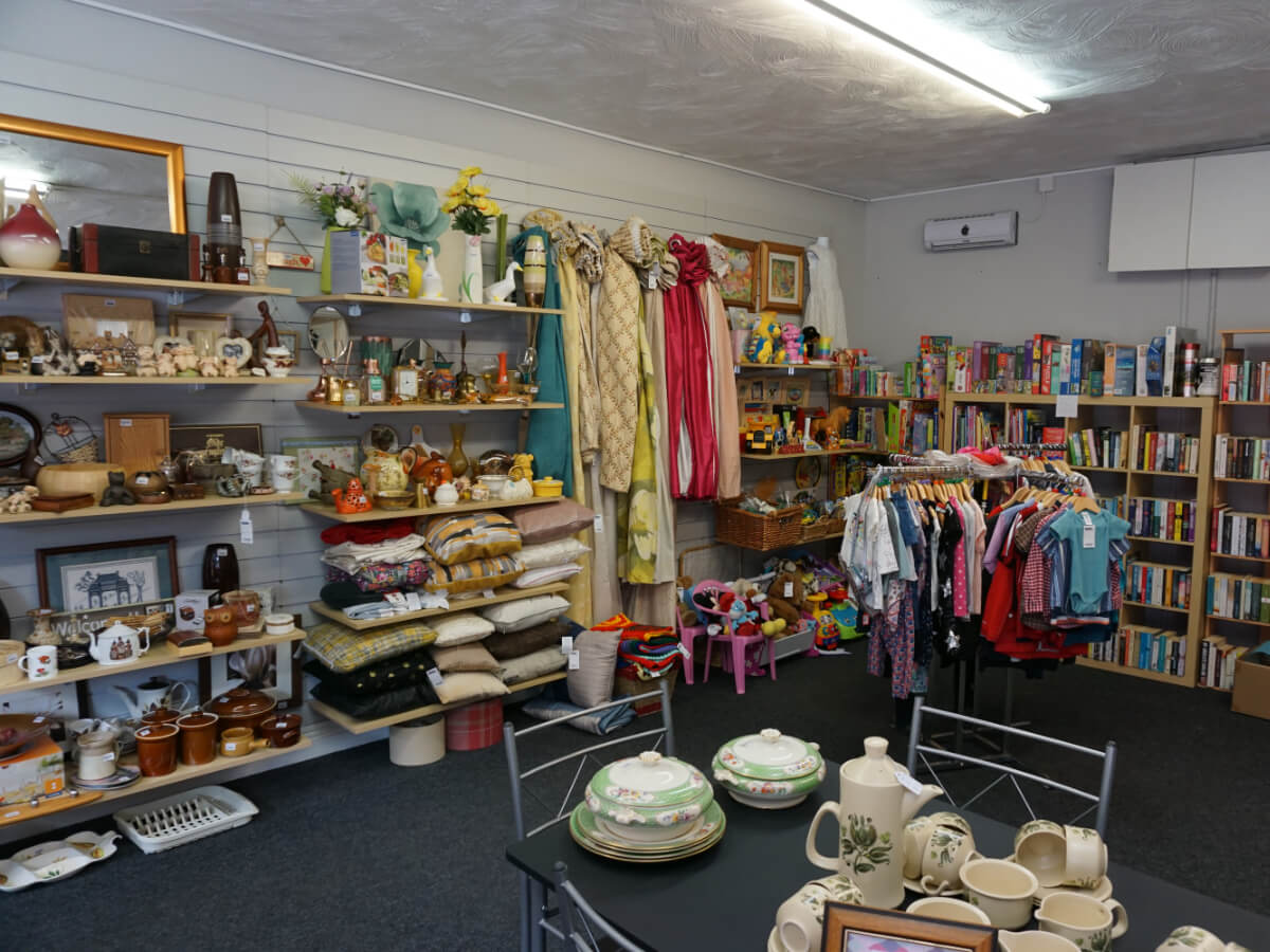 interior of a shop with shelves of books and bric a brac