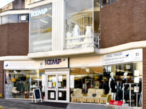 external photo of a kemp hospice charity shop showing a glass fronted building