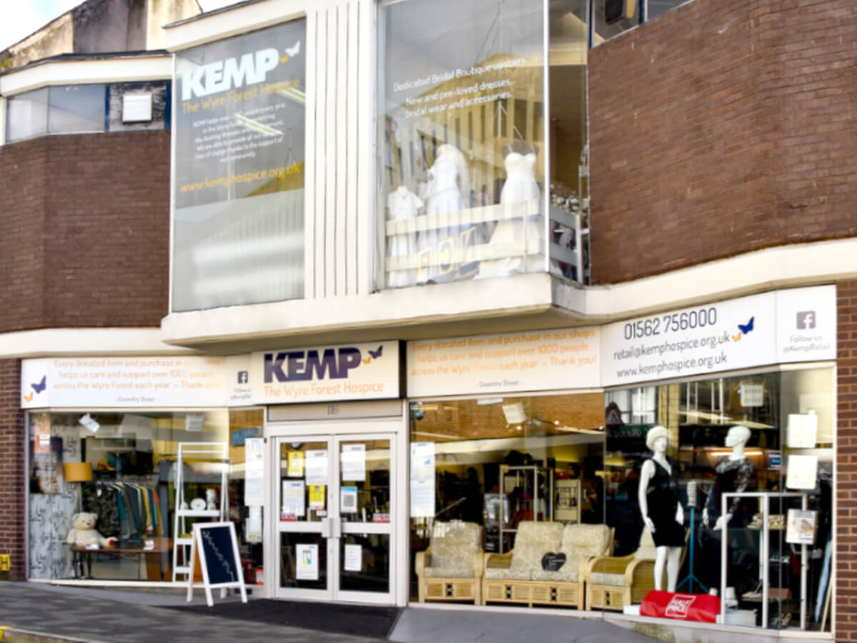 external photo of a kemp hospice charity shop showing a glass fronted building