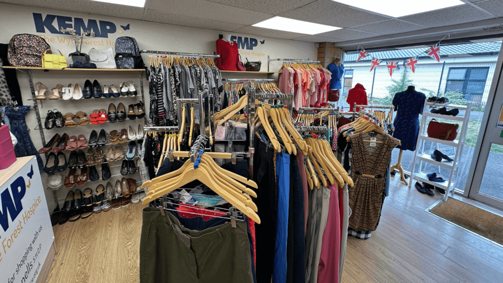 interior of a shop with clothes hanging on rails.