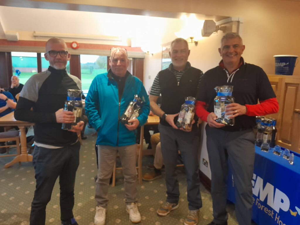 four people stand holding prizes