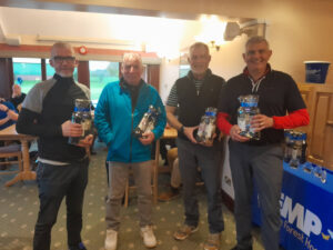four people stand holding prizes