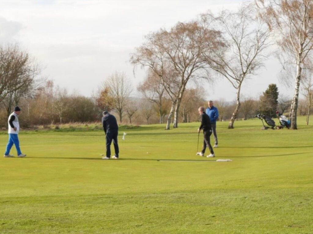 a group of people on a golf course