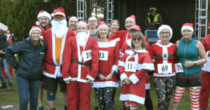 Group of people wearing santa suits