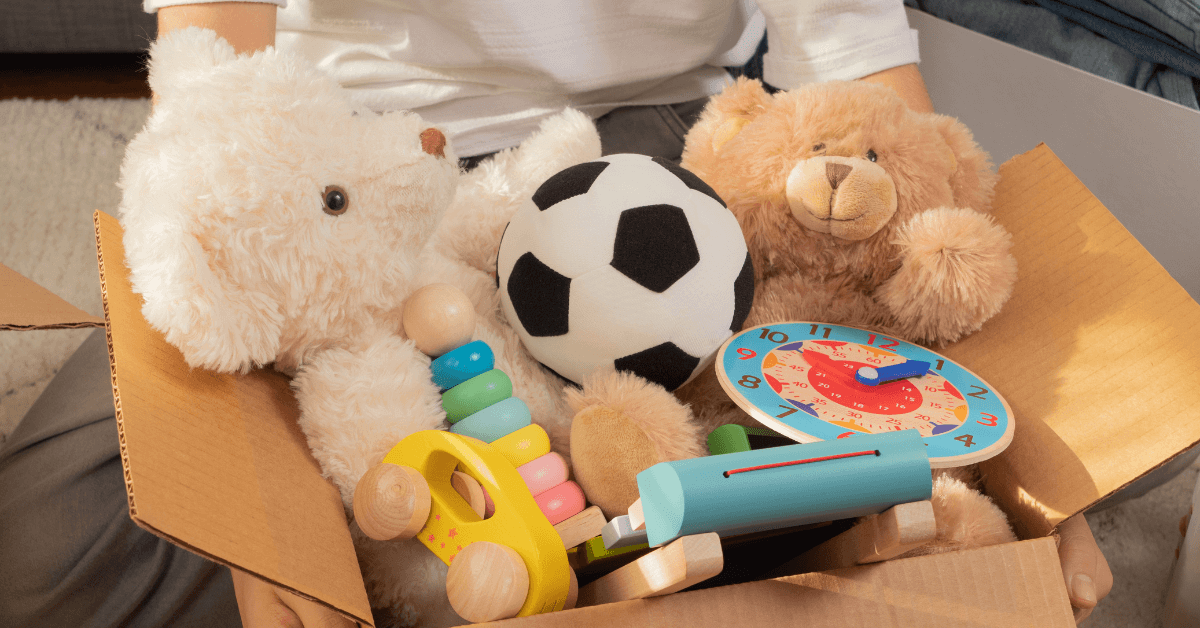 Cardboard box with toys and games inside for donations