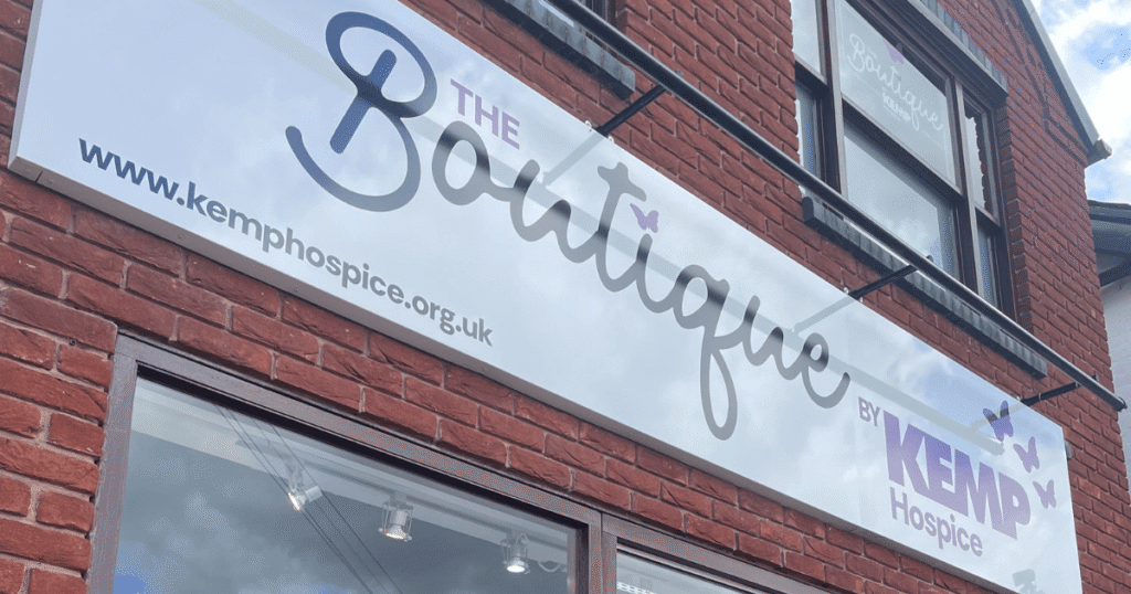 a close up of a white sign on a brick building