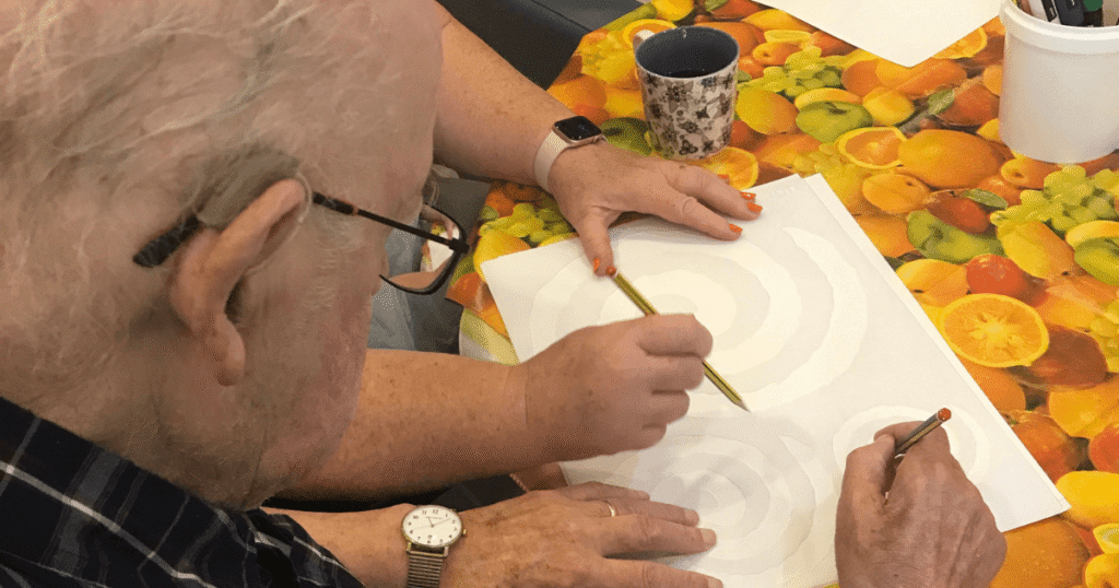 close up of a gentleman drawing a picture on paper