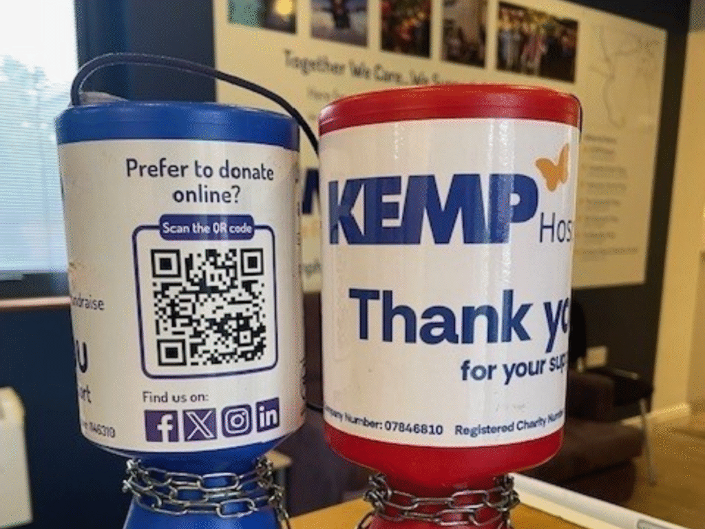 close up picture of two collection tins, one is blue on the left and one is red on the right.