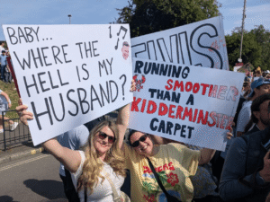 two ladies hold signs as supporters of the london marathon runners