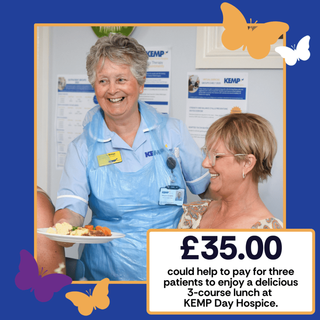 a lady wearing blue nurse uniform serves another lady a plate of food with both smiling