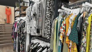 a variety of colourful womens clothing on a clothes rail