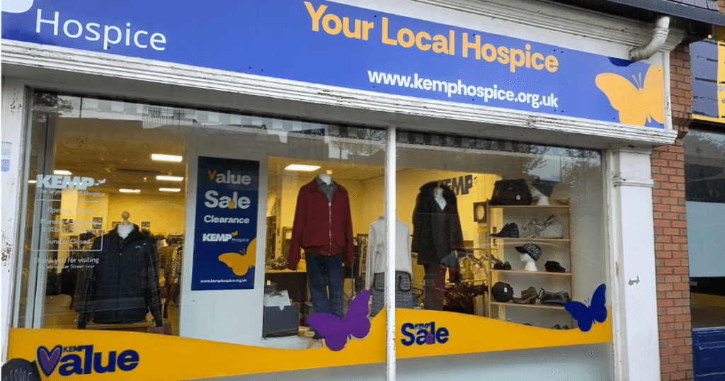 External shop facade with clothing items in the windows on display
